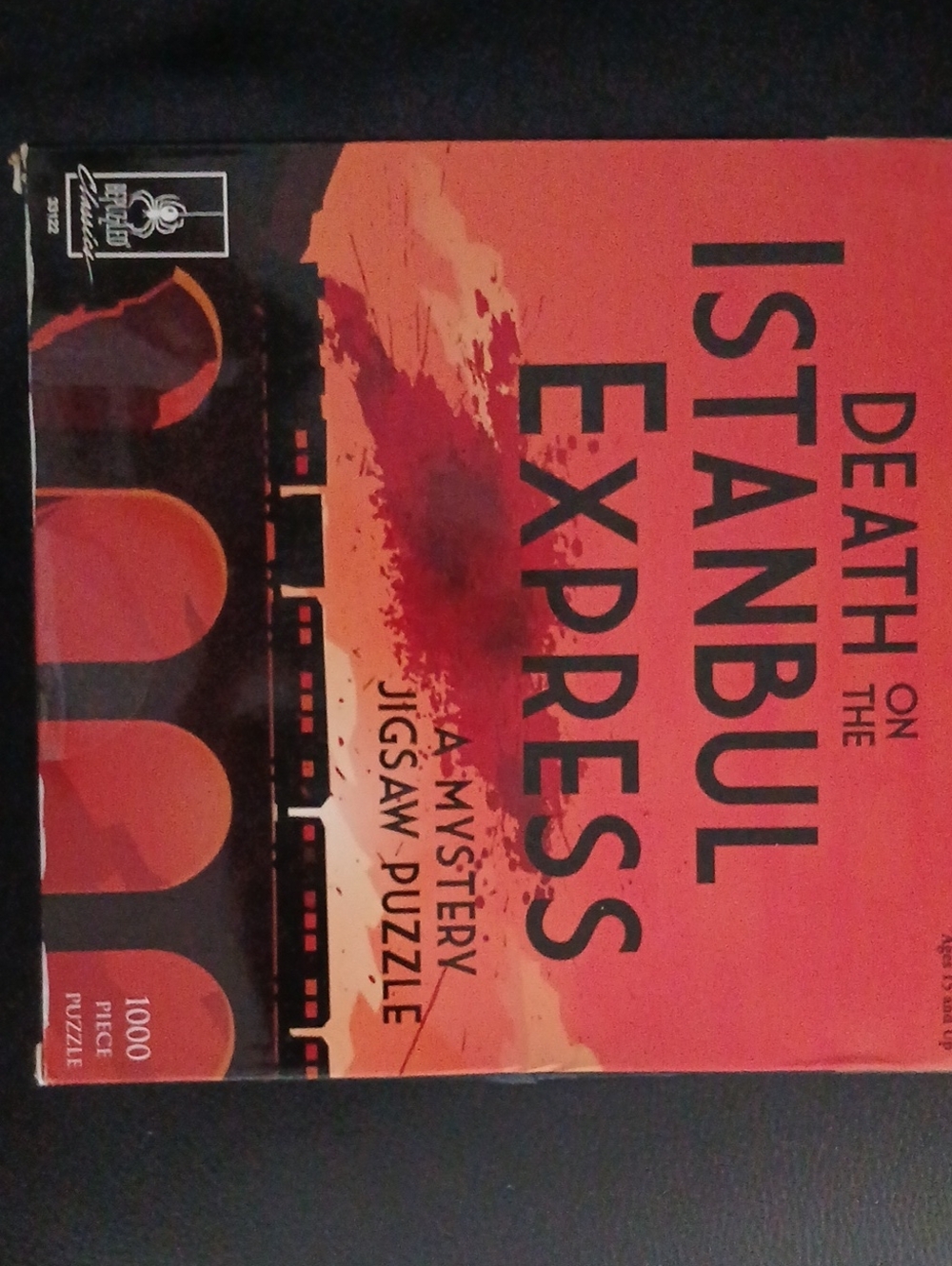 Ravensburger Death on the Istanbul Express Puzzle - Black, Gold & Orange